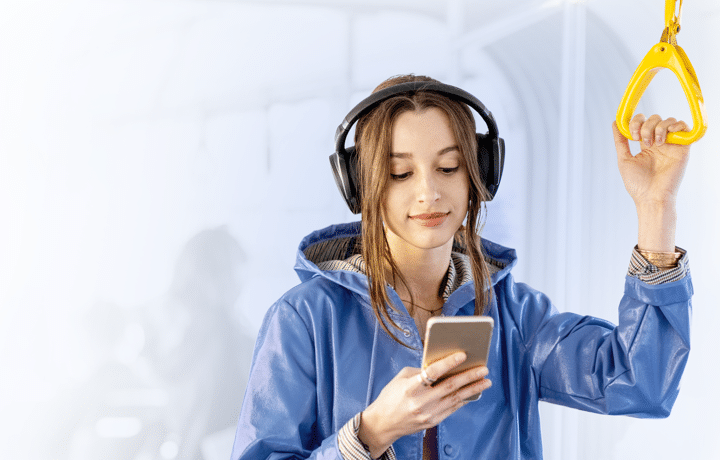 Woman travelling on public transport looking at her phone