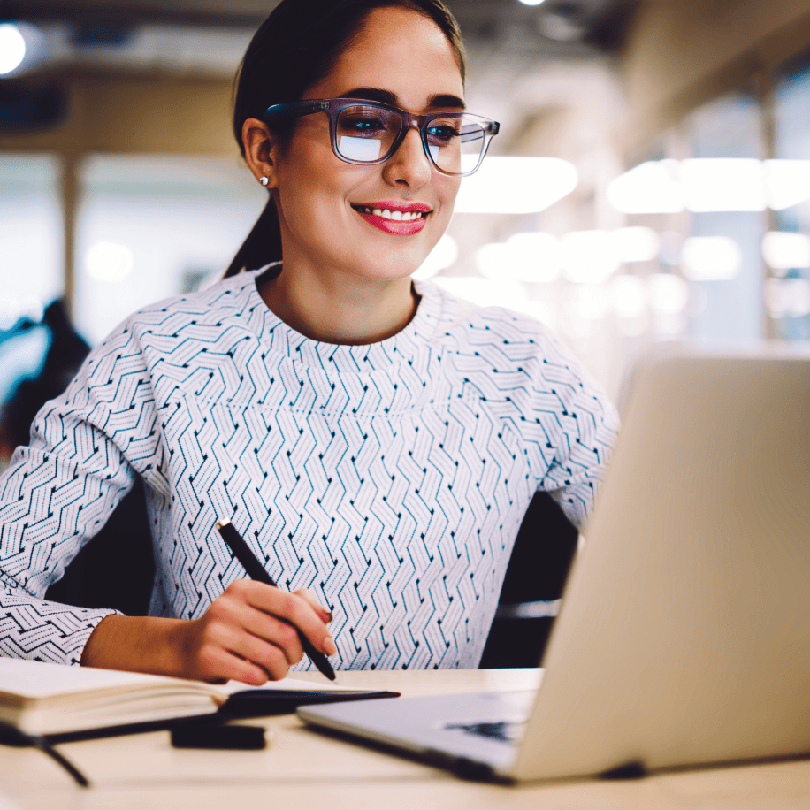 Woman looking at a laptop smiling